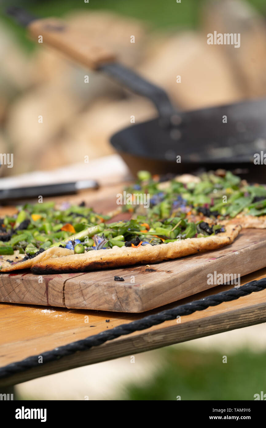 A Sour Dough Pizza Prepared Outdoors And Cooked On A Firepit