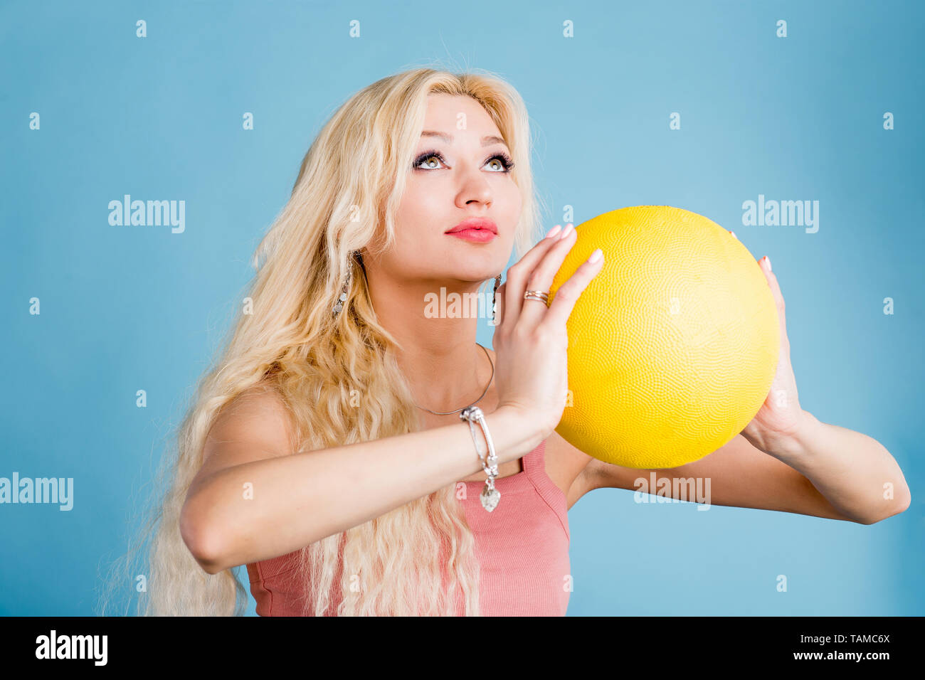Beautiful blonde girl standing basketball hires stock photography and