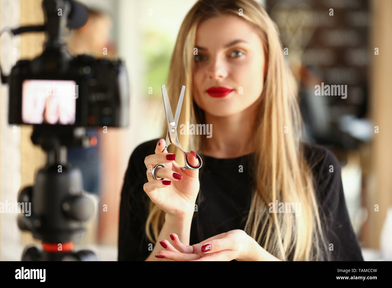 Blonde Woman Blogger Holding Metallic Scissors Stock Photo