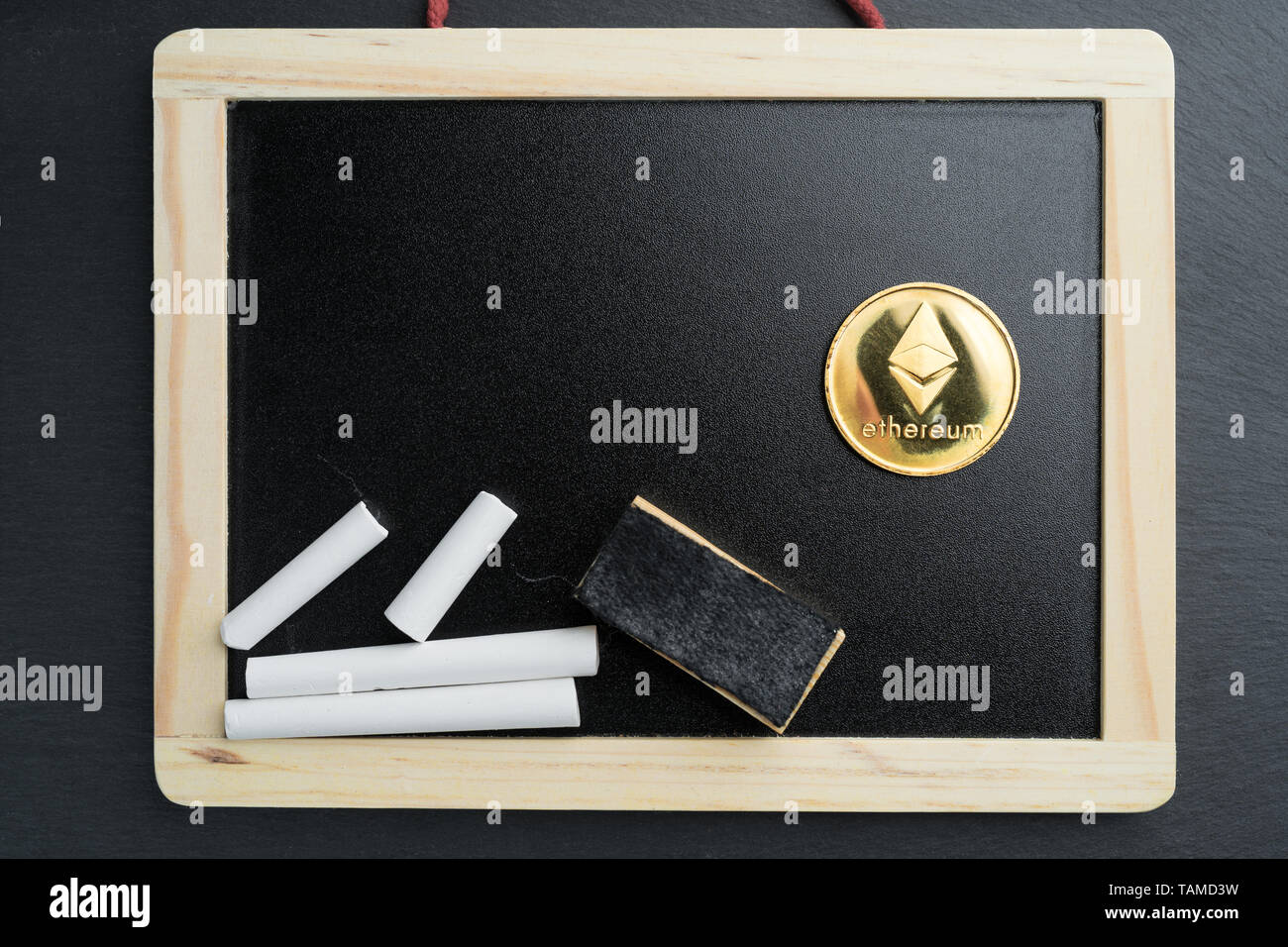 Physical Ethereum gold coin on a blackboard with chalk. Cryptocurrency  education abstract concept Stock Photo - Alamy