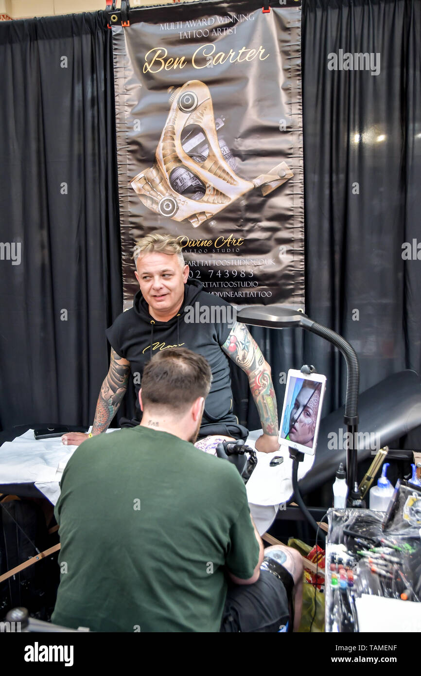 London, UK. 26th May, 2019. Ben Carter, Tattoo a client at The Great British Tattoo Show, on 26 May 2019, London, UK. Credit: Picture Capital/Alamy Live News Stock Photo