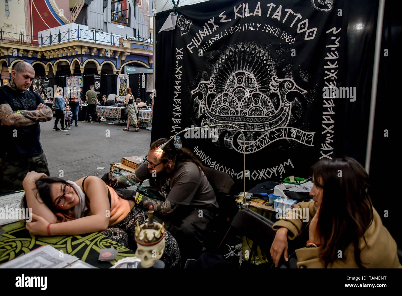 London, UK. 26th May, 2019. Fiumax & Kila tattoo, Tattoo a client at The Great British Tattoo Show, on 26 May 2019, London, UK. Credit: Picture Capital/Alamy Live News Stock Photo