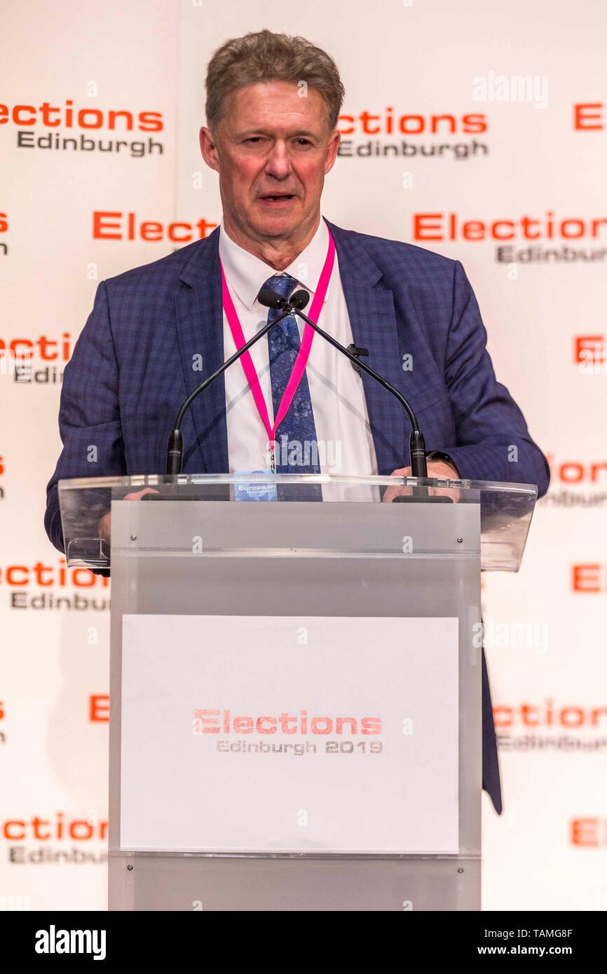 Edinburgh, UK. 26th May, 2019. The counting of votes in the European Parliamentary Election for the City of Edinburgh counting area takes place at EICC, Morrison Street, Edinburgh.   Pictured: Andrew Kerr, Local Returning Officer for Edinburgh District Count announcing the turnout for the district of 50.2% Credit: Rich Dyson/Alamy Live News Stock Photo