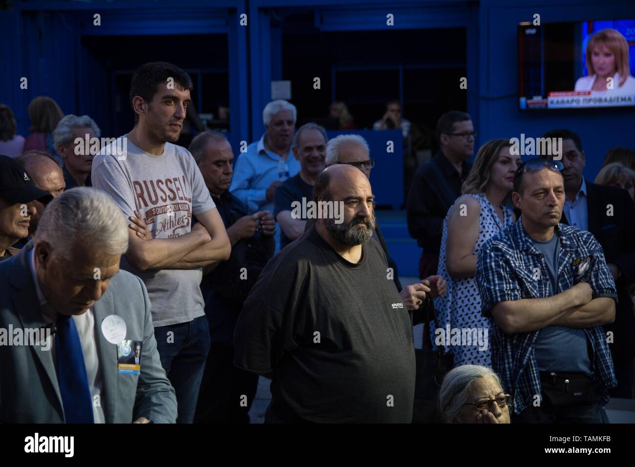 New Democracy party (ND) supporters seen at an electoral kiosk reacting during the first results of exit poll in the centre of Athens. Stock Photo