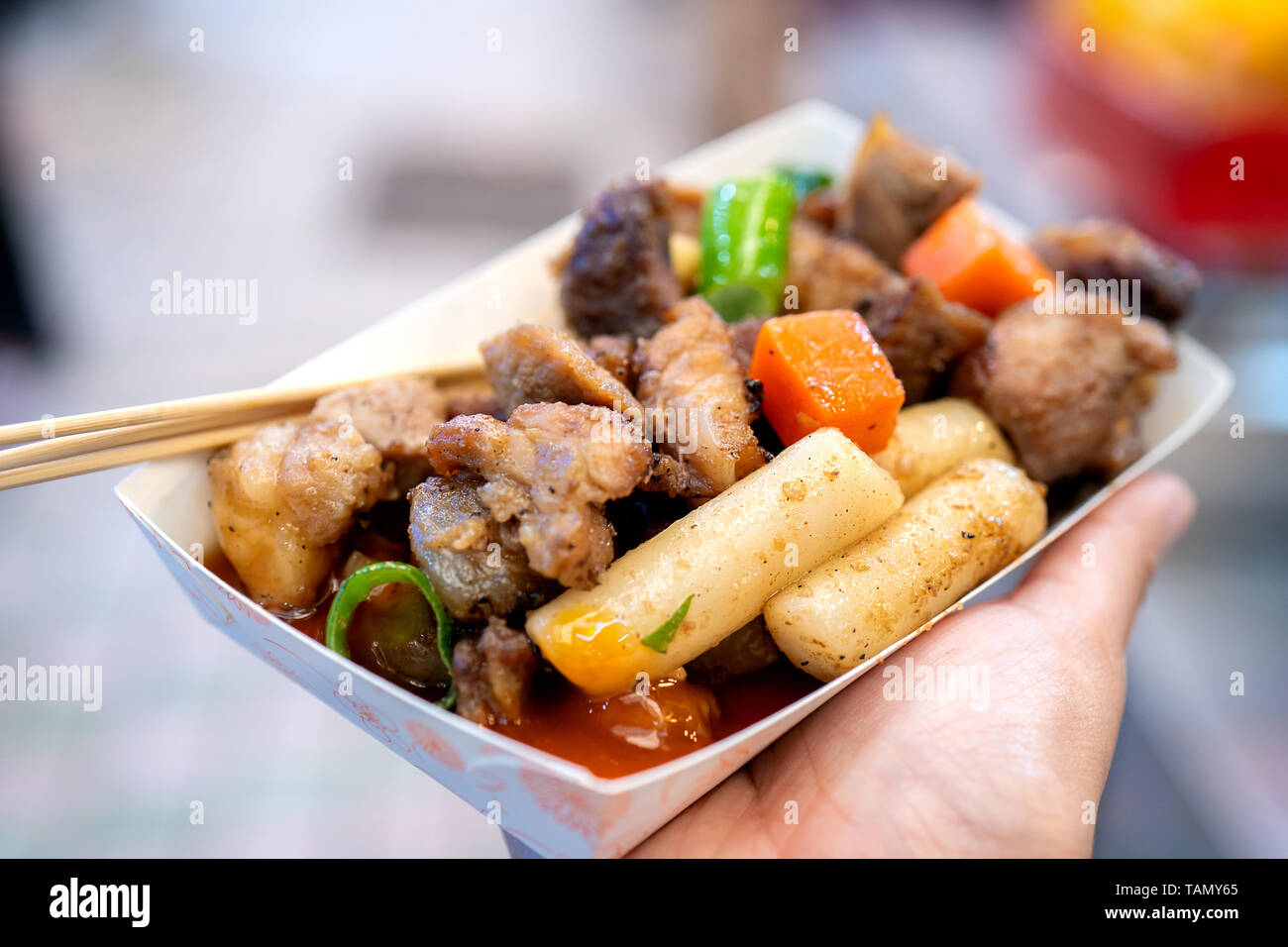 Pan-fried black pork meal in Korea traditional market, delicious korean food cuisine with carrot and shallot green onion, close up, copy space Stock Photo
