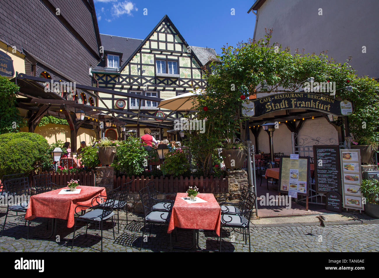 Wine tavern and beer garden at historic half-timbered house, Ruedesheim, Upper Middle Rhine Valley, Rheingau, Hesse, Germany Stock Photo