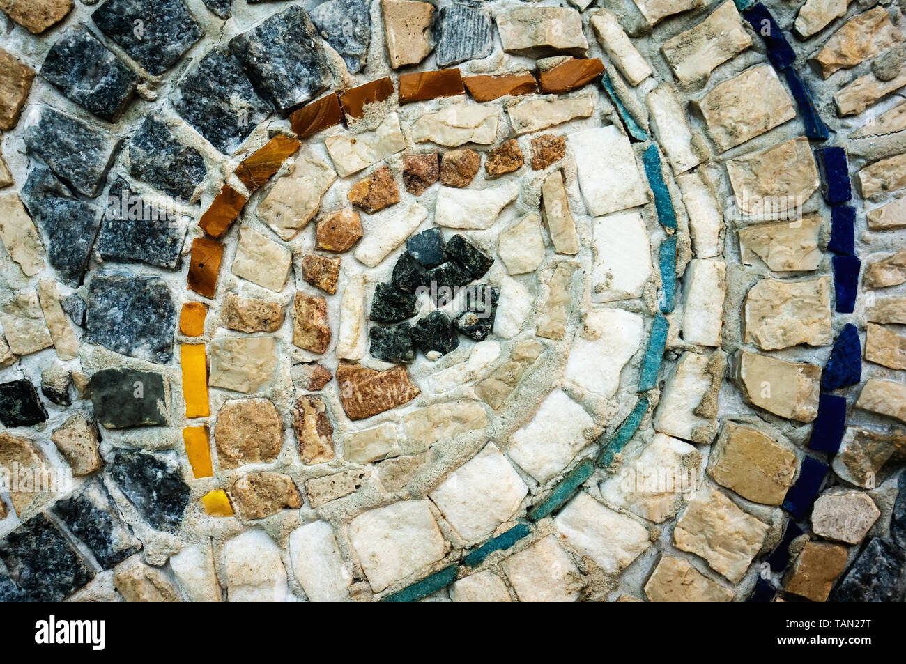 A fragment of the wall of small colored stones. The texture of the ...