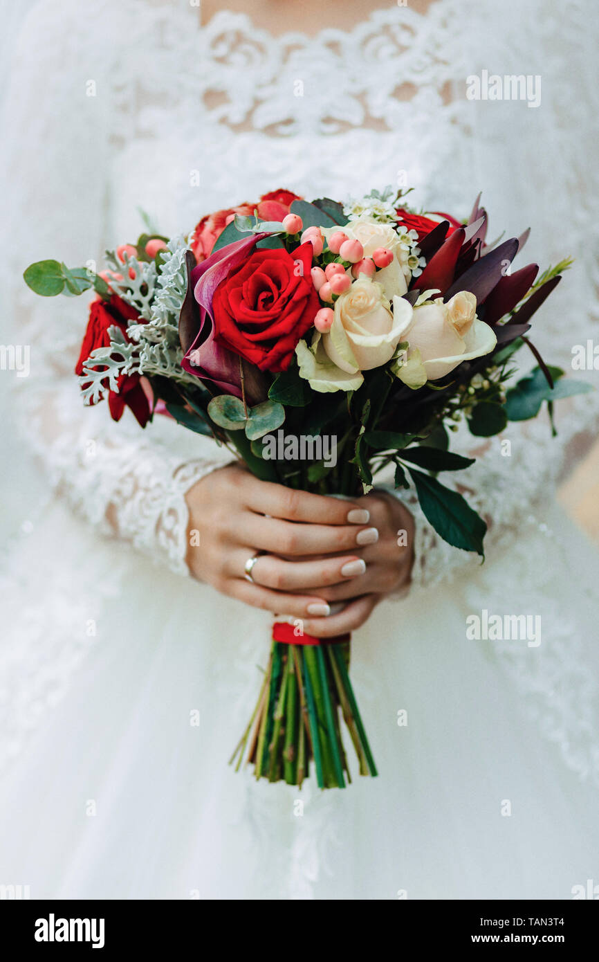 the bride holds a wedding bouquet in her hands, wedding day flowers ...