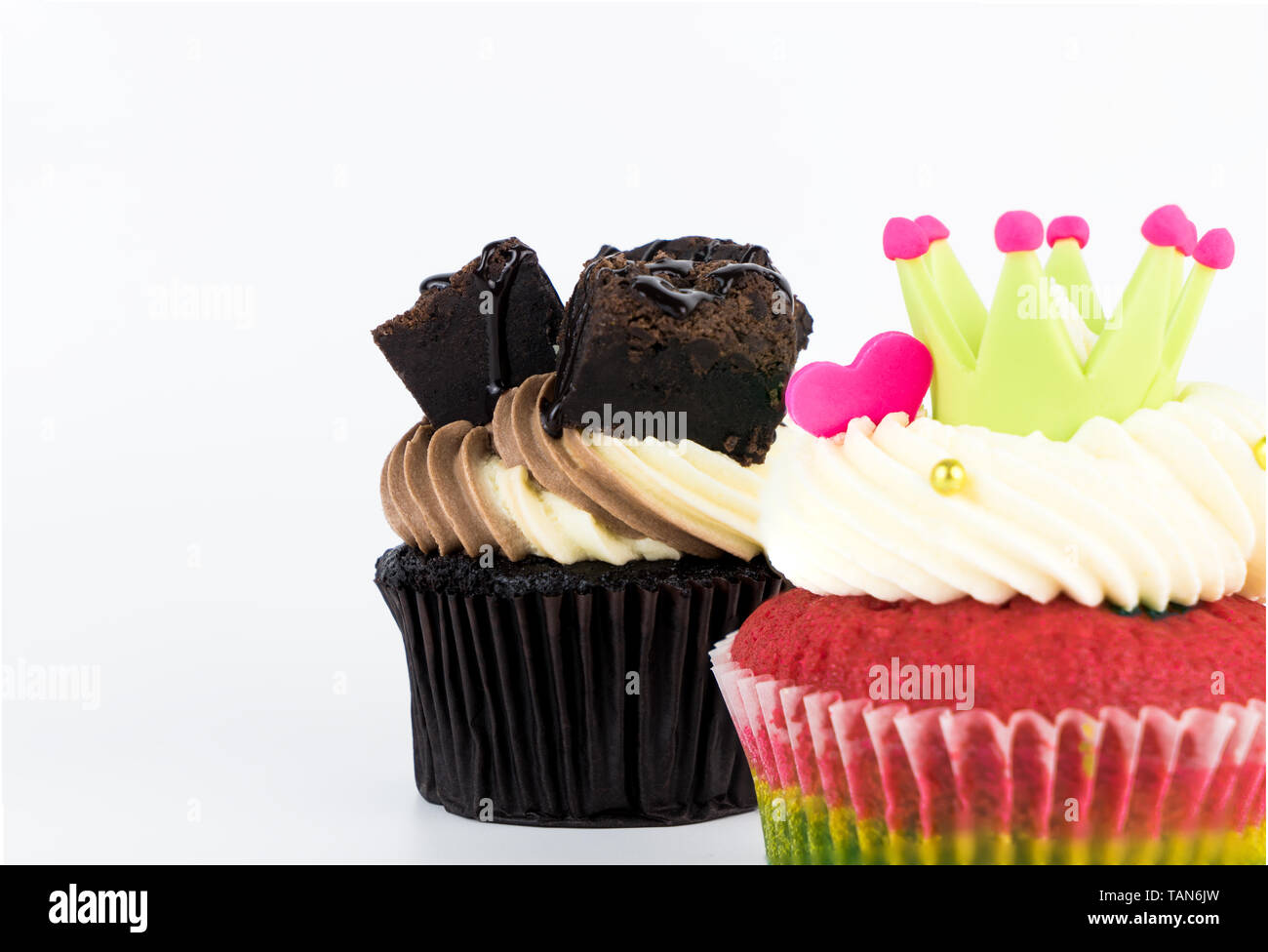 Chocolate and rainbow cupcake isolated on white background Stock Photo