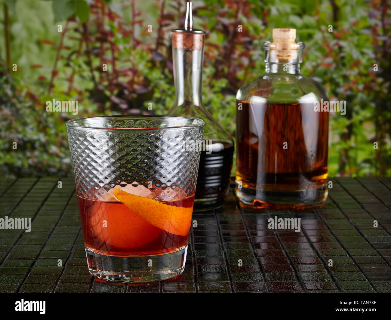 Old fashioned: a cocktail made by muddling sugar with bitters, then adding bourbon, and a twist of citrus rind Stock Photo