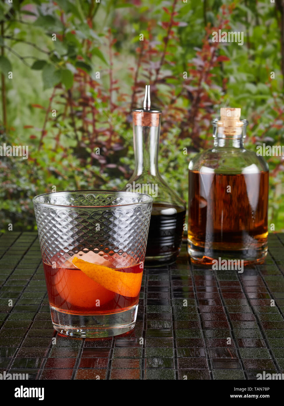 Old fashioned: a cocktail made by muddling sugar with bitters, then adding bourbon, and a twist of citrus rind Stock Photo