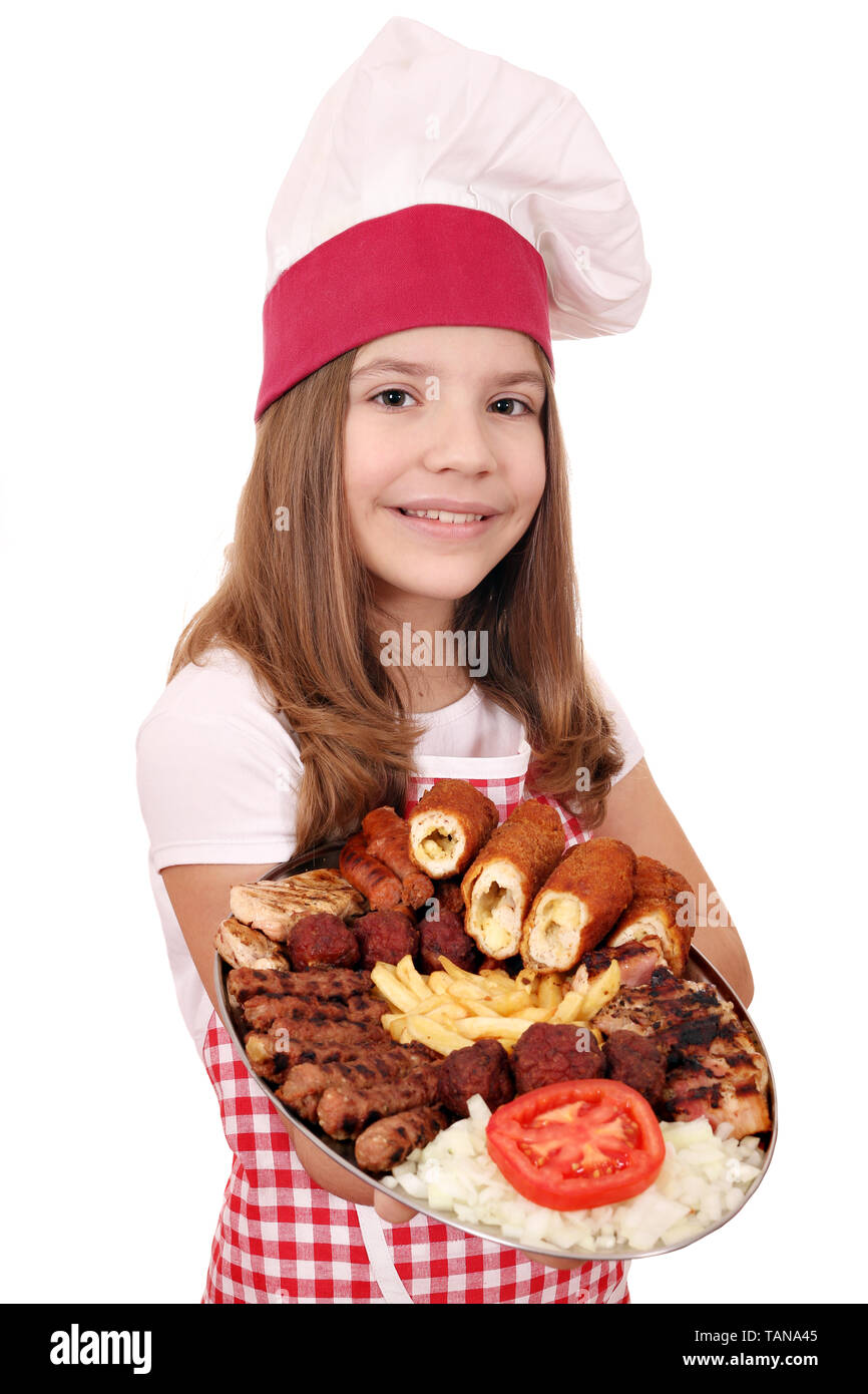happy little girl cook with mixed grilled meat and salad on plate Stock Photo