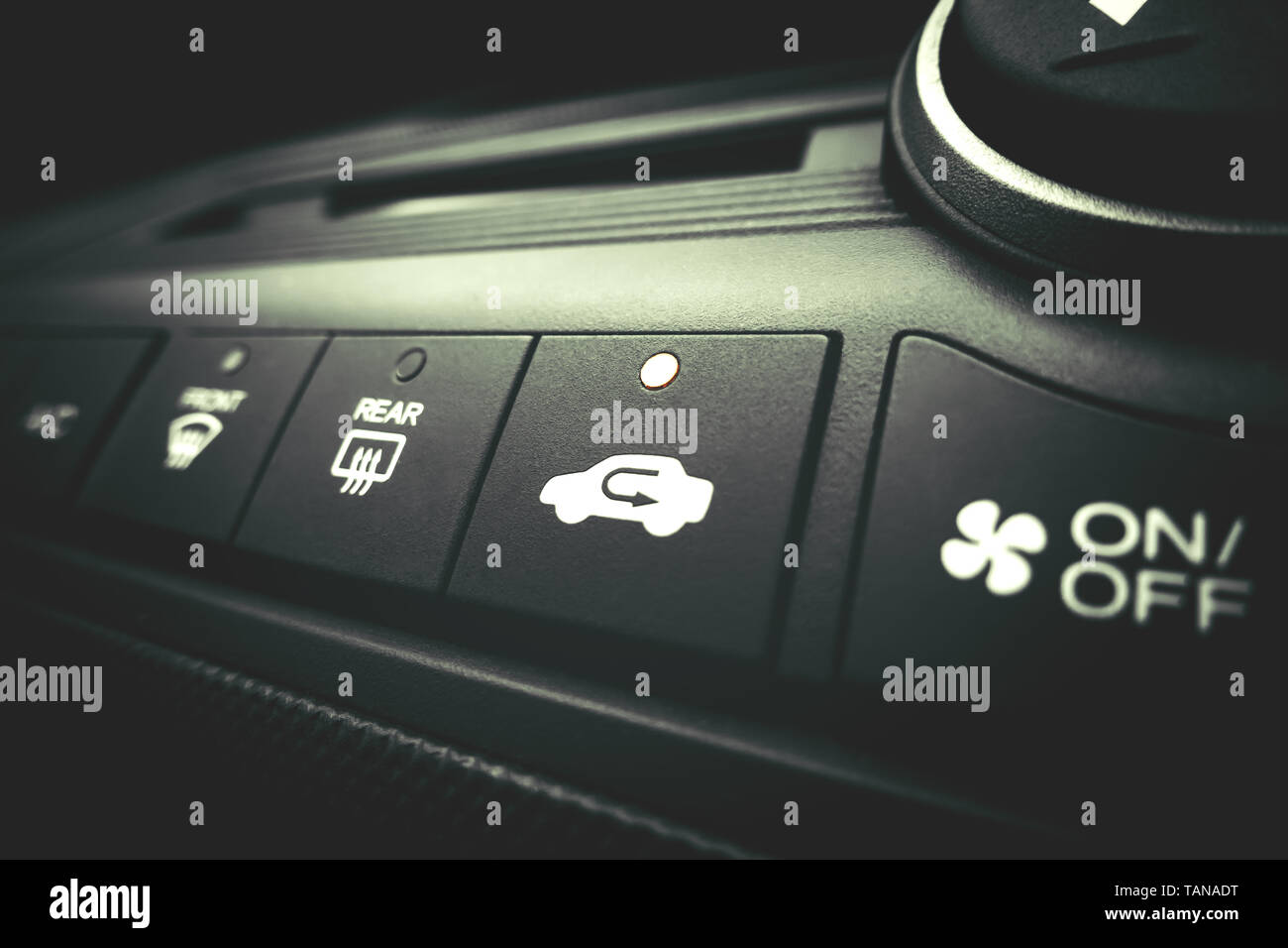 Finger pressing on Power switch of a Car air conditioning system Stock