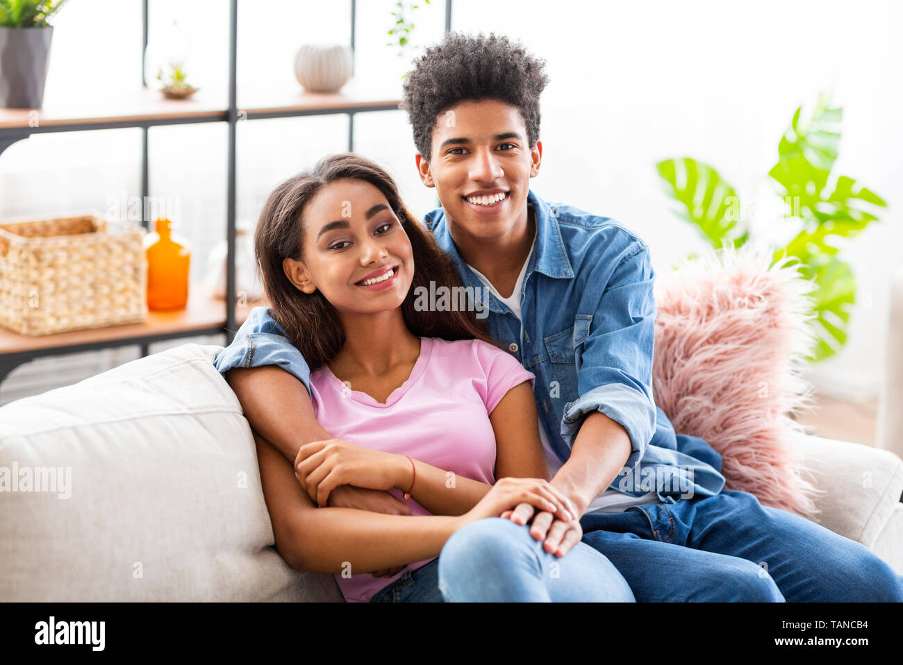 Happy teen lovers having rest at home Stock Photo