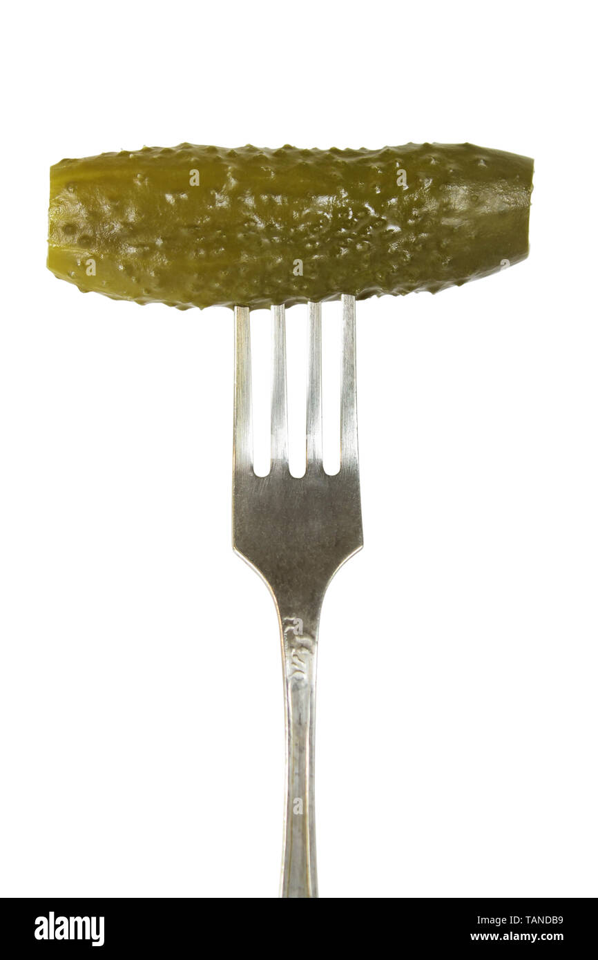 Pickled cucumber on a fork isolated on white Stock Photo