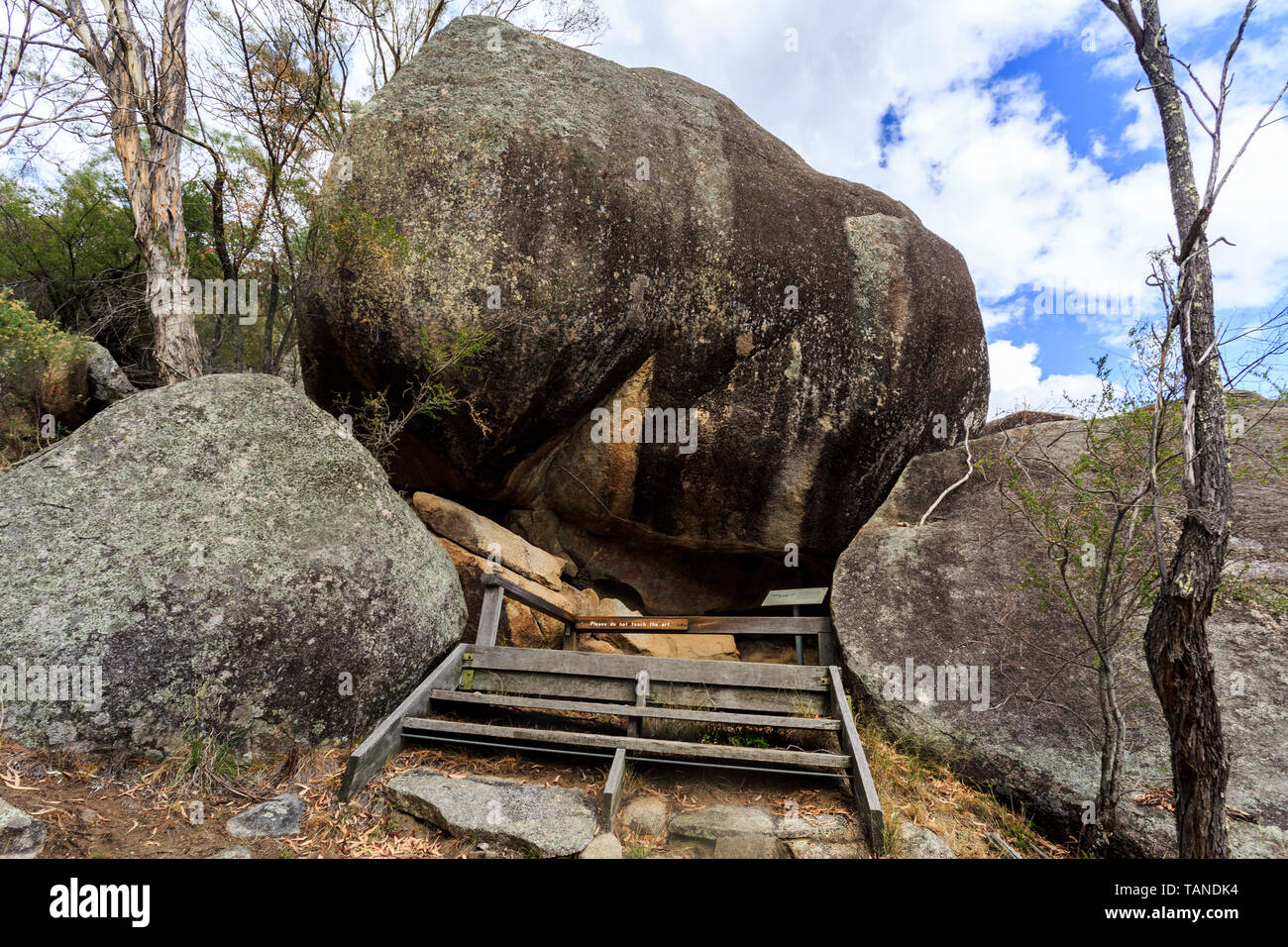 Weathered tors, or granite boulders, creating the little cave where the Anaiwan Aboriginal people painted their rock art some hundred years ago, near  Stock Photo