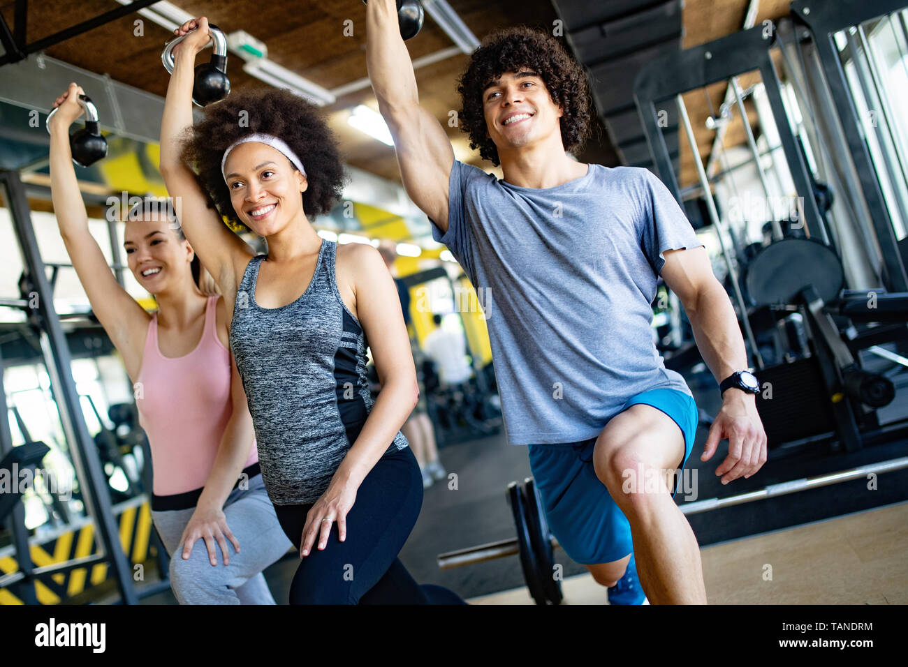 Group of sportive people in a gym training Stock Photo - Alamy
