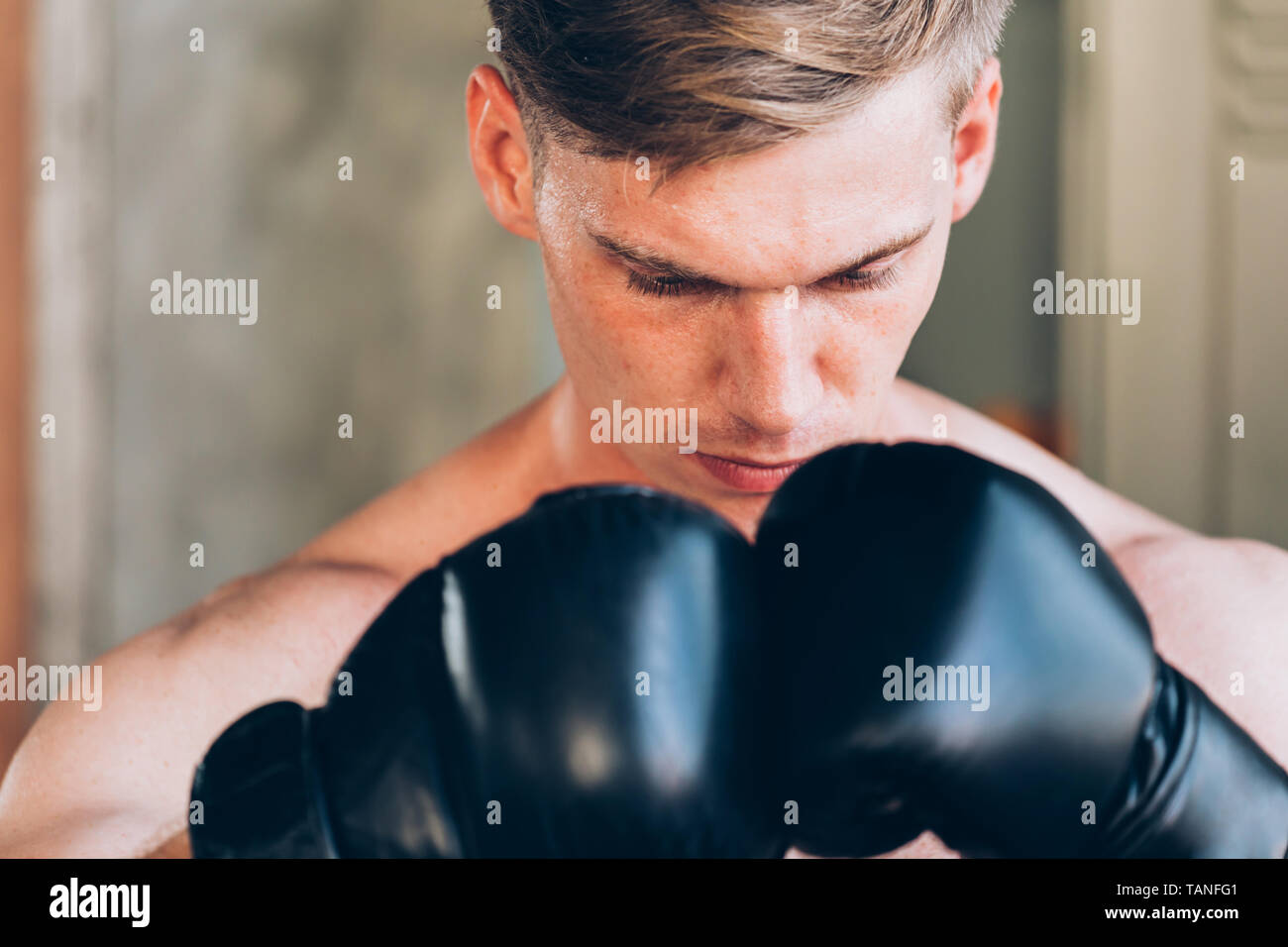 Closeup Of Young Caucasian Male Boxer Wear Boxing Gloves In