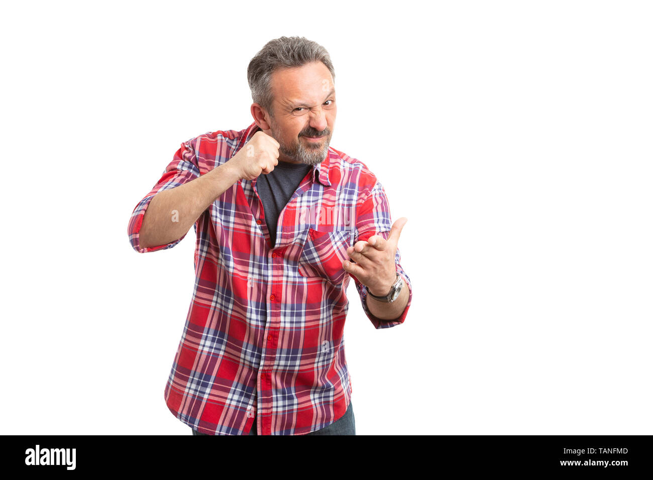 Angry man threatening by making gesture with fist and palm isolated on white studio background Stock Photo