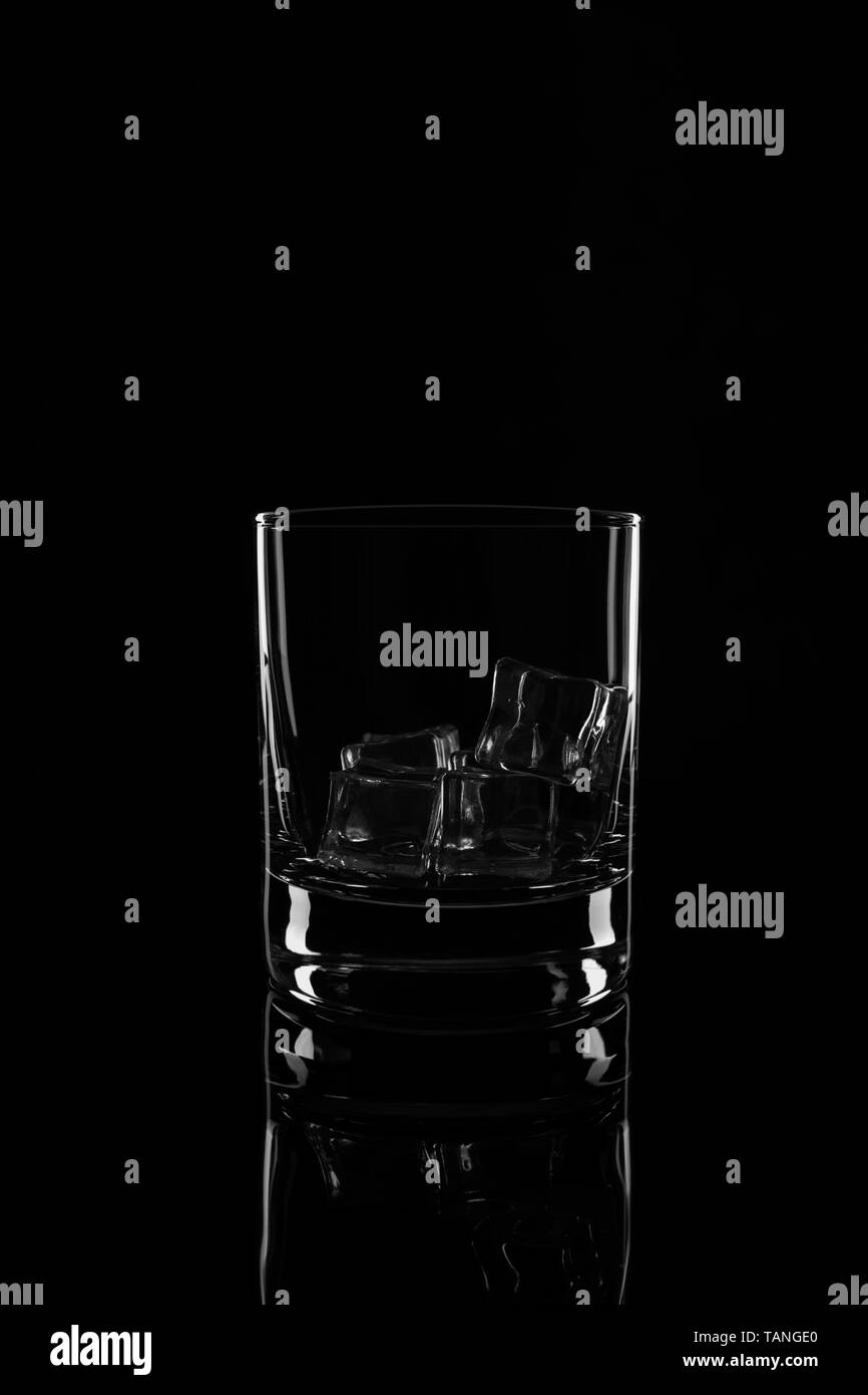 Glass with ice cubes, isolated on a black background Stock Photo - Alamy
