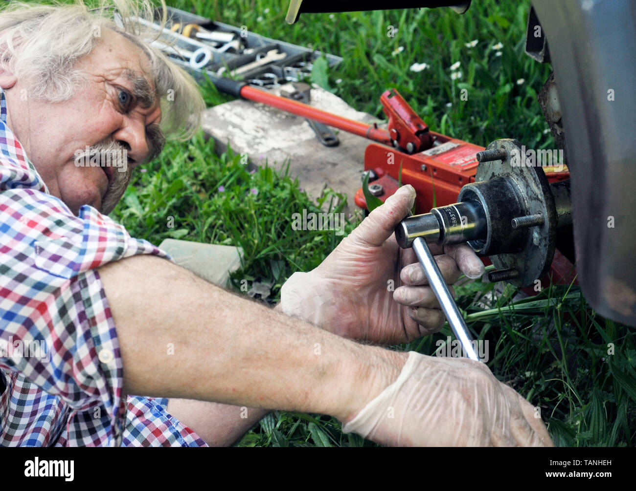 mechanic tightening hub nut on trailer wheel Stock Photo Alamy