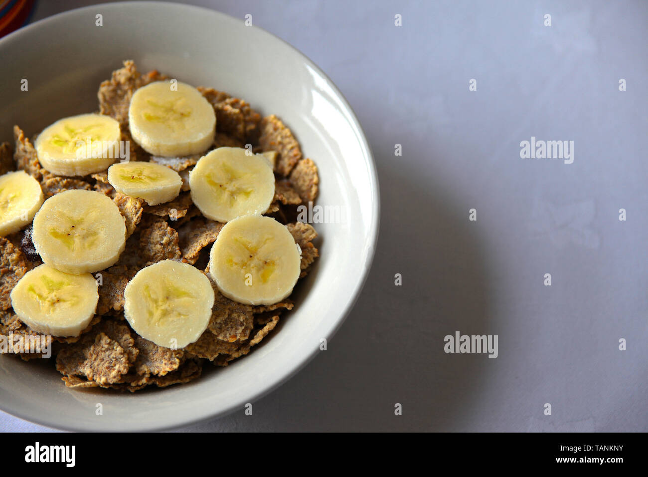 Close up healthy breakfast of bran flakes and banana. Stock Photo