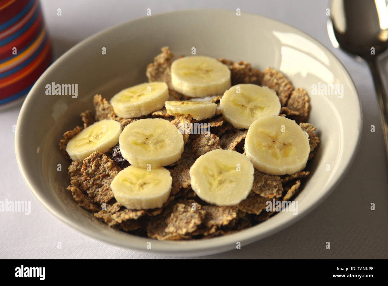 Close up healthy breakfast of bran flakes and banana. Stock Photo