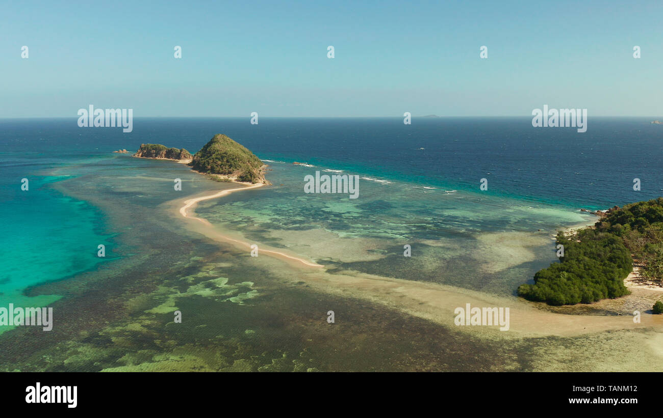 aerial view tropical island in blue lagoon, coral reef and sandy beach ...