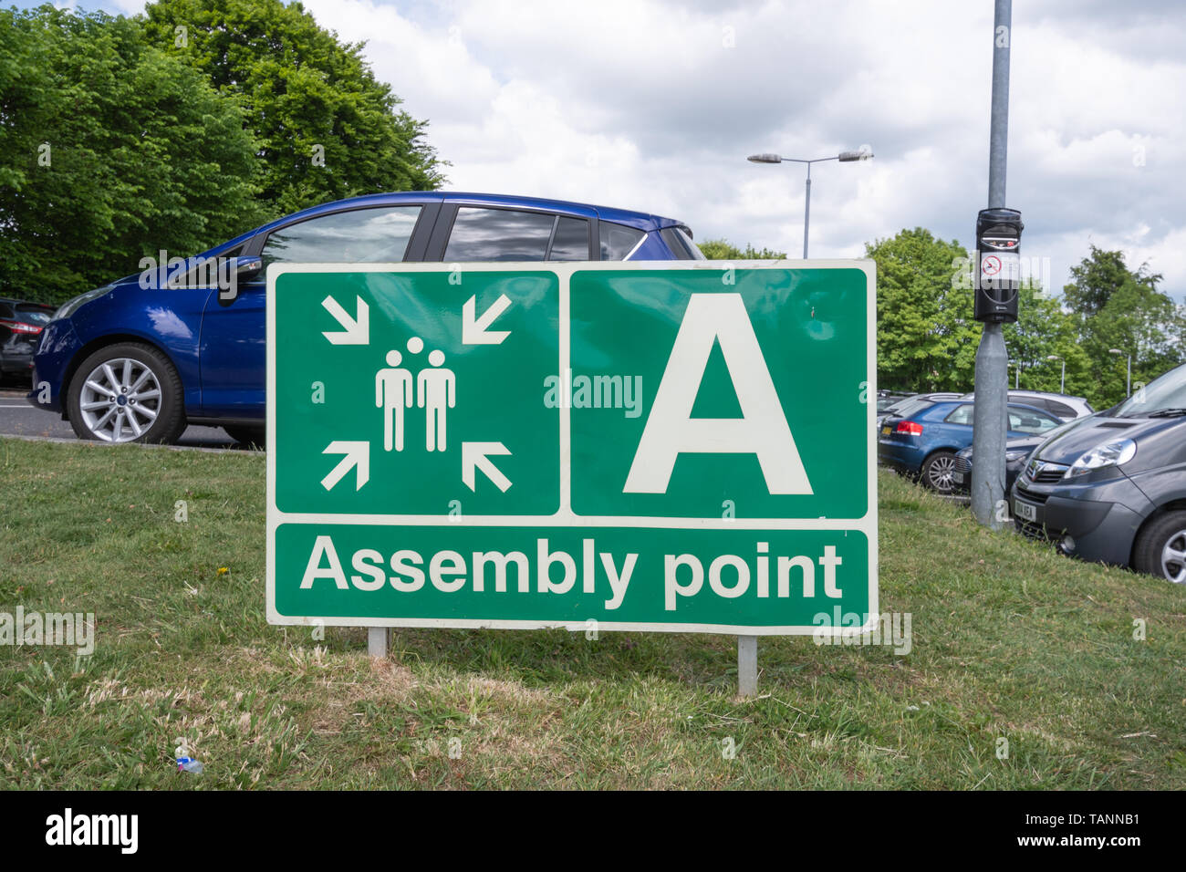 Fire assembly point sign in a car park, where people assemble after