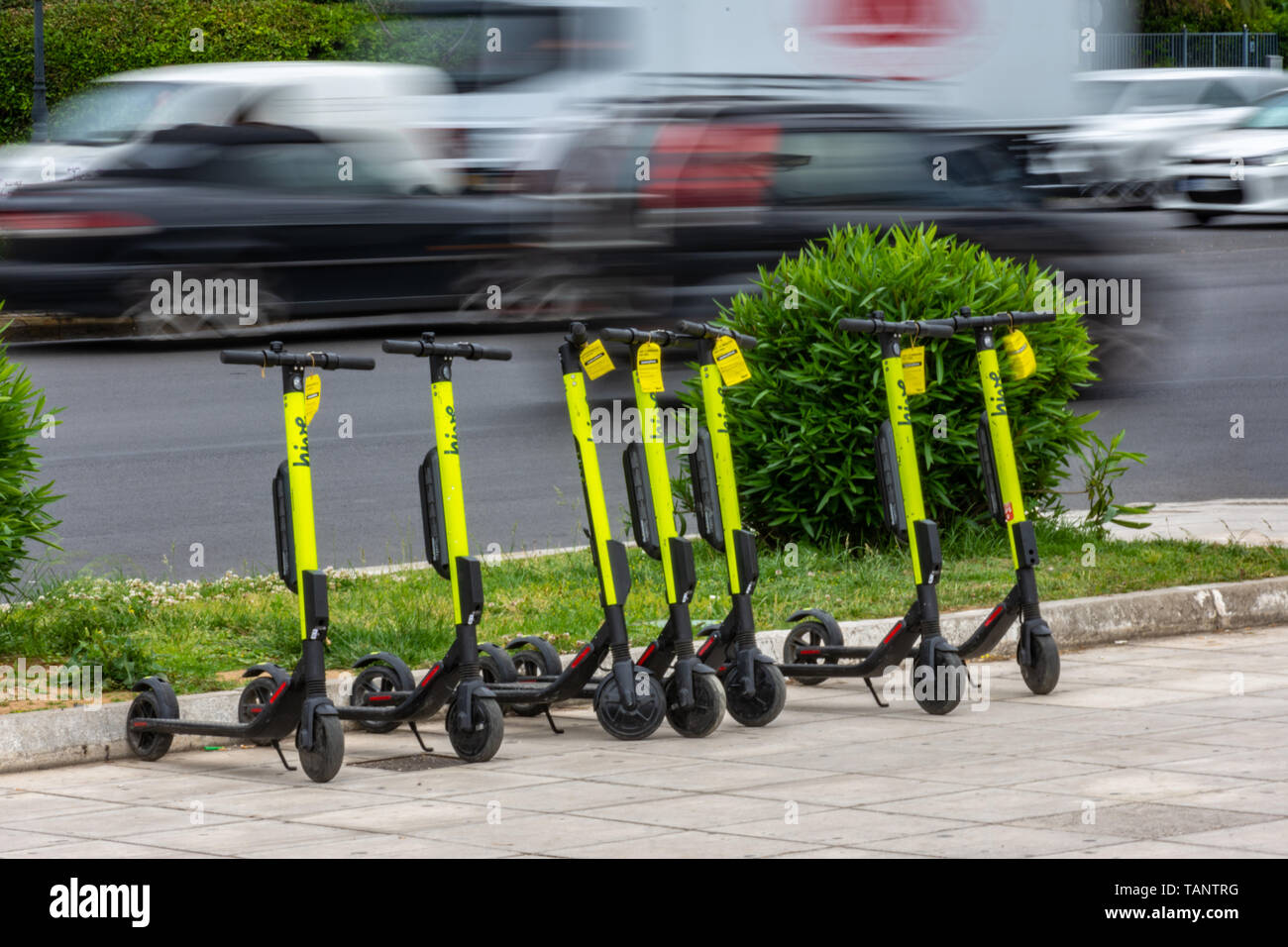 Electric scooters parked in sidewalk in downtown Athens, Greece Stock