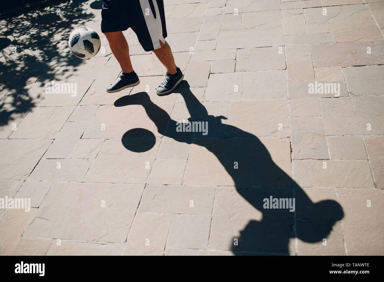 Soccer player kicks the ball Stock Photo