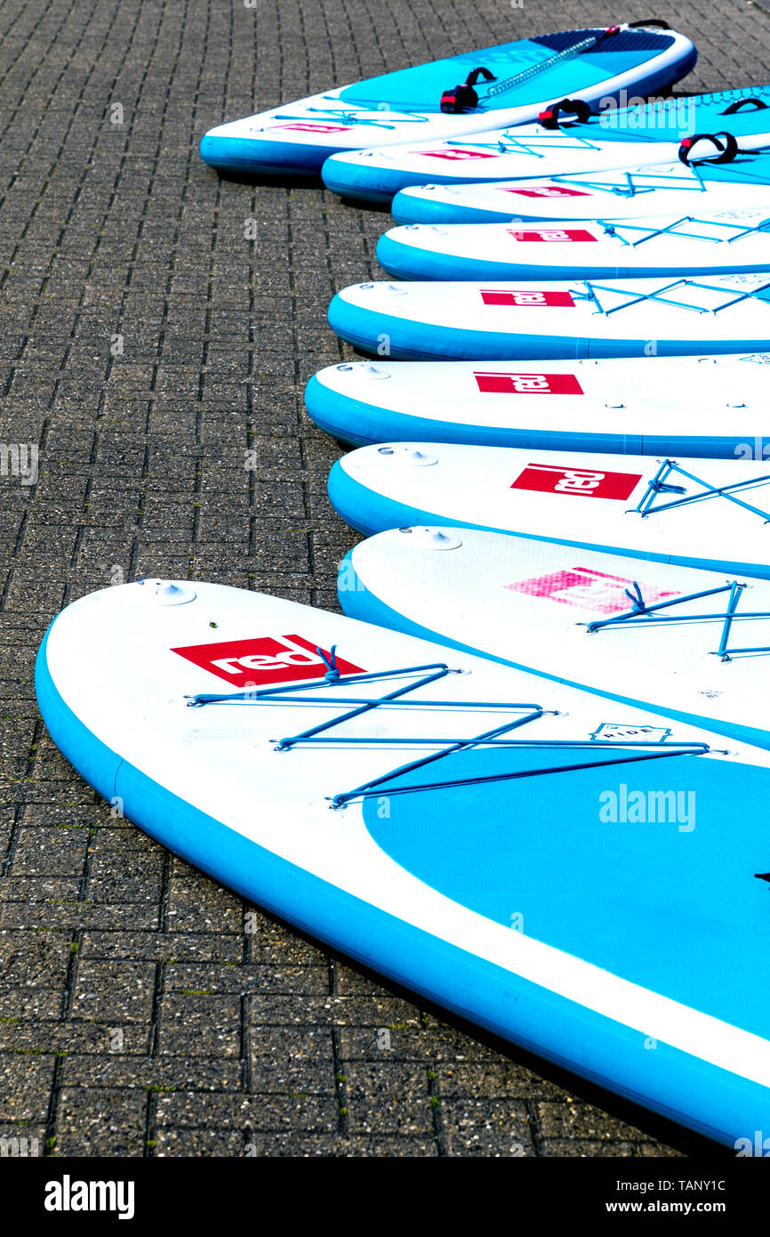 Paddle boards laid out on the ground Stock Photo
