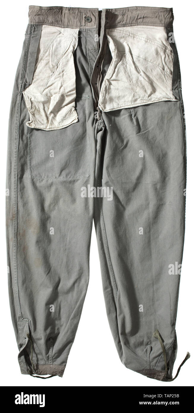A light special clothing issue outfit of panzer or assault gun units depot piece Unlined tunic of field-grey cotton cloth with light cardboard buttons in special clothing issue cut, however with a slanted double covered fly and left-sided large superimposed front pocket with closure flap, underarm ventilation holes and reinforced side seam openings for a belt. BeVo eagle, silhouettes of collar tabs. The trousers of same material with field-grey cardboard buttons, integrated black web belt and covered fly, both front pockets of unlike size and integrated at different angles,, Editorial-Use-Only Stock Photo