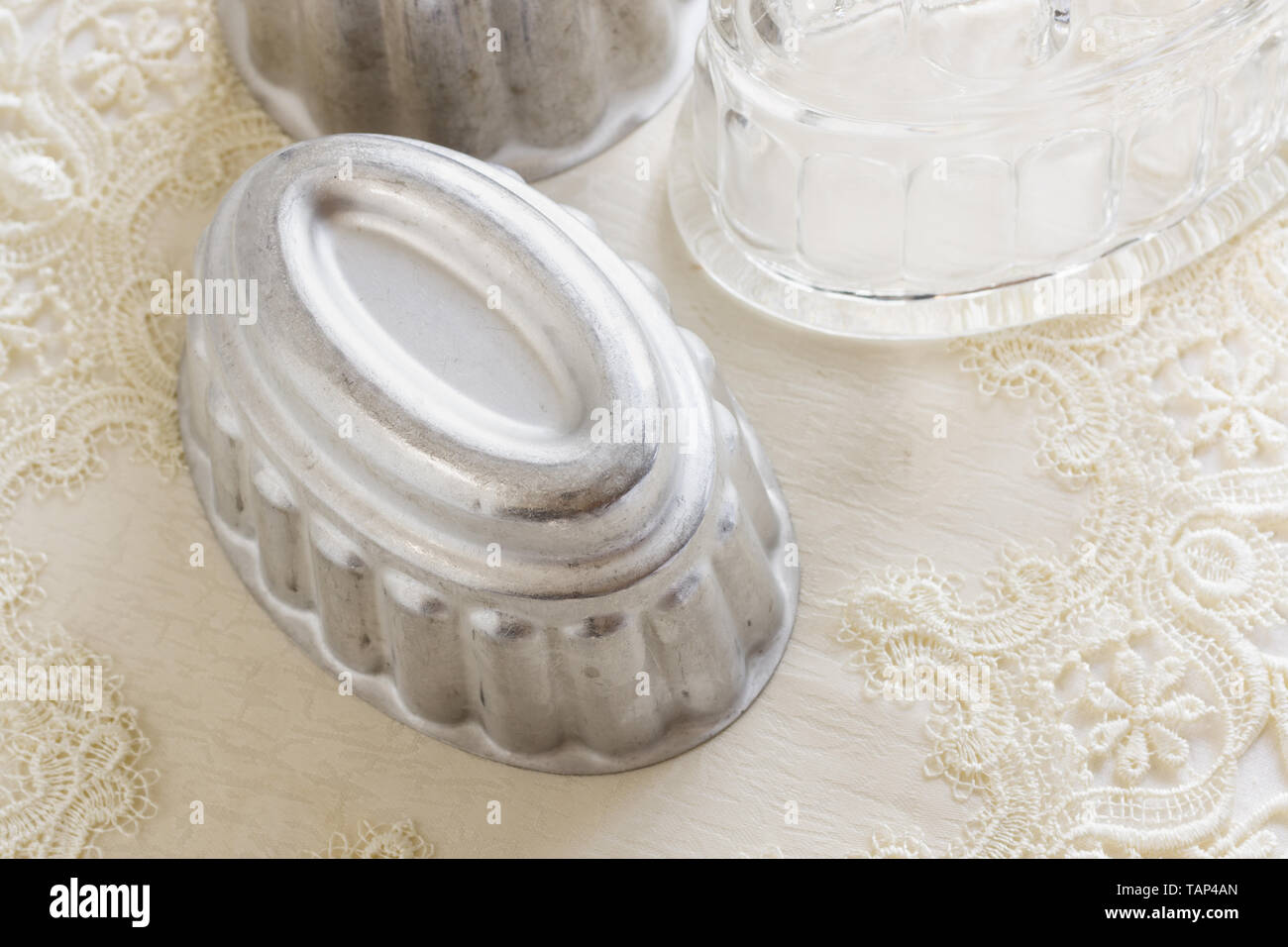 Old fashioned glass and aluminum jelly or blancmange moulds for making traditional jellies Stock Photo