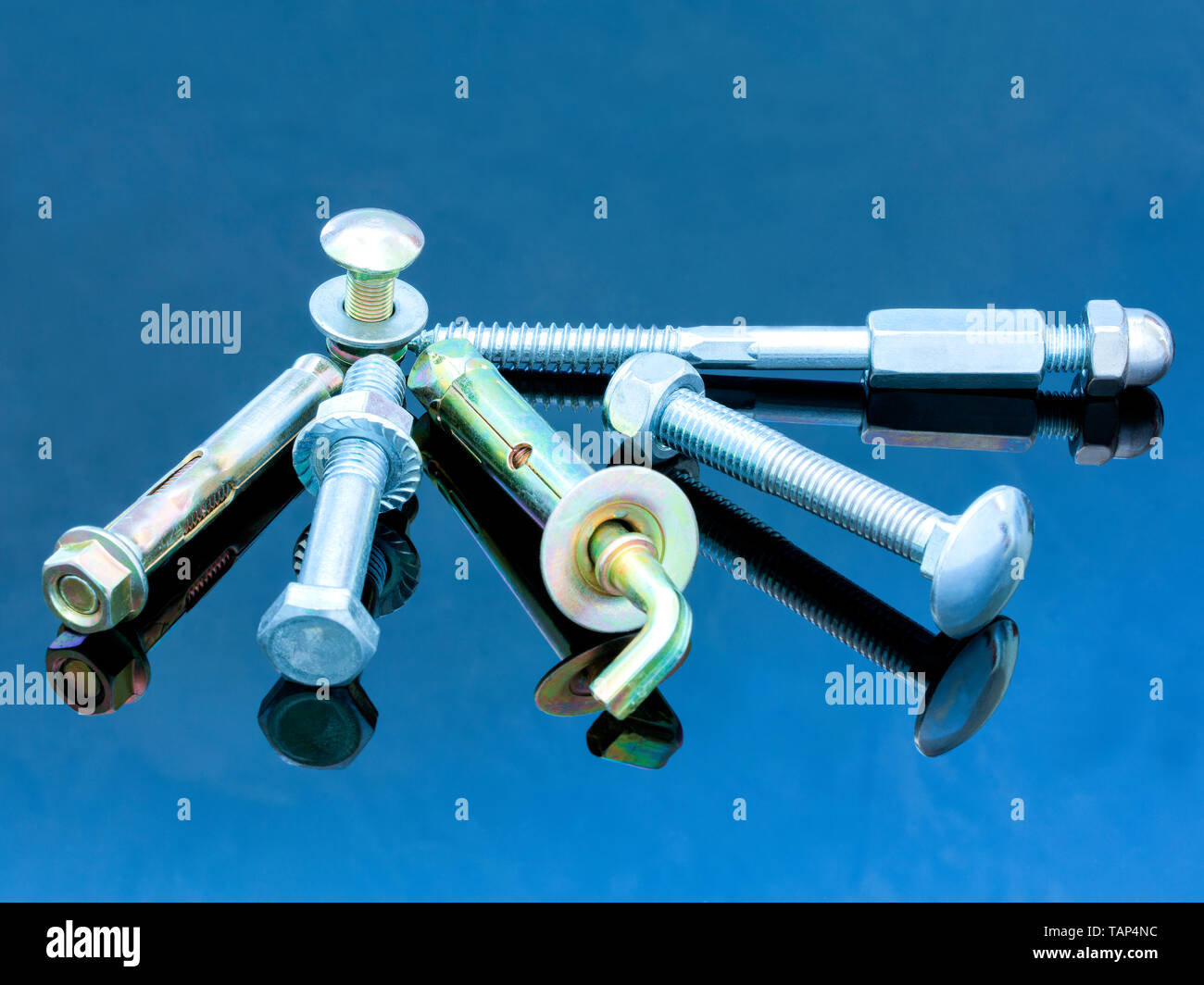 Various equipment screw bolts and bolts with washers on a glossy dark