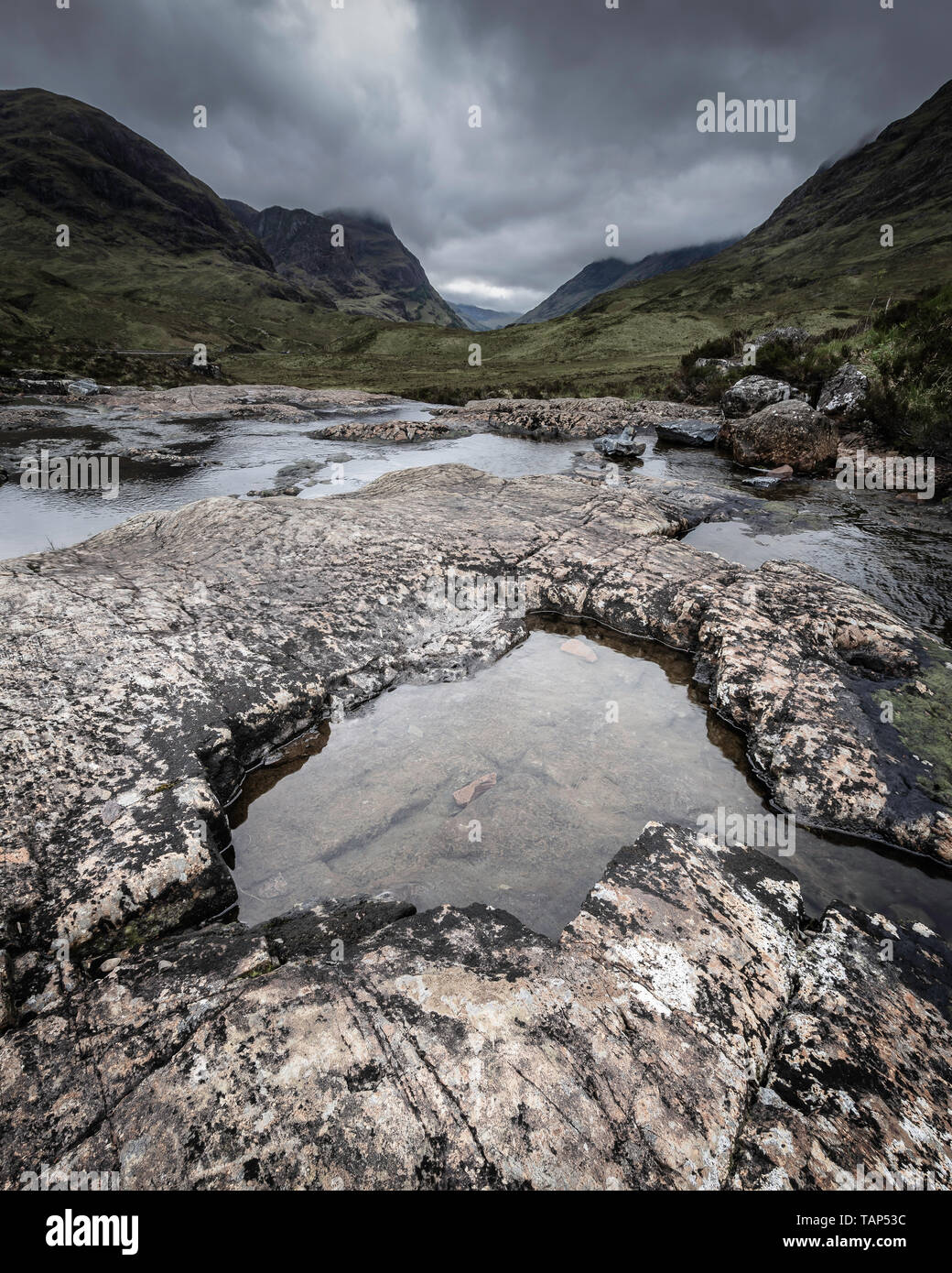 Majestic landscape of Scotland.Moody sky over scenic mountain valley. Stream with clean water 