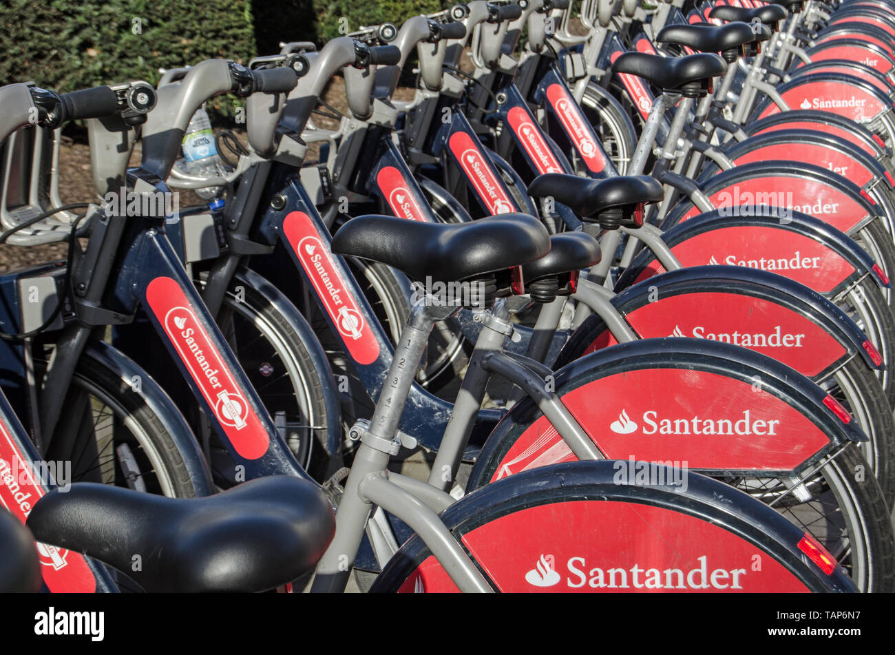 LONDON, UK - JANUARY 28, 2016:  A rack full of public transport bicycles sponsored by the bank company Santander. Stock Photo