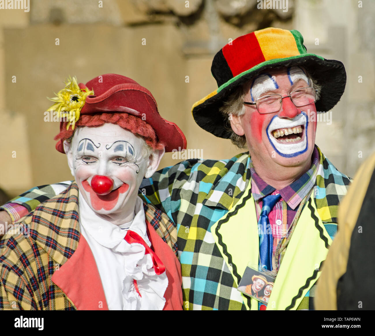 LONDON, UK - FEBRUARY 7, 2016:  Two clowns sharing a joke ahead of the annual church service in memory of Joseph Grimaldi held at All Saints Church in Stock Photo