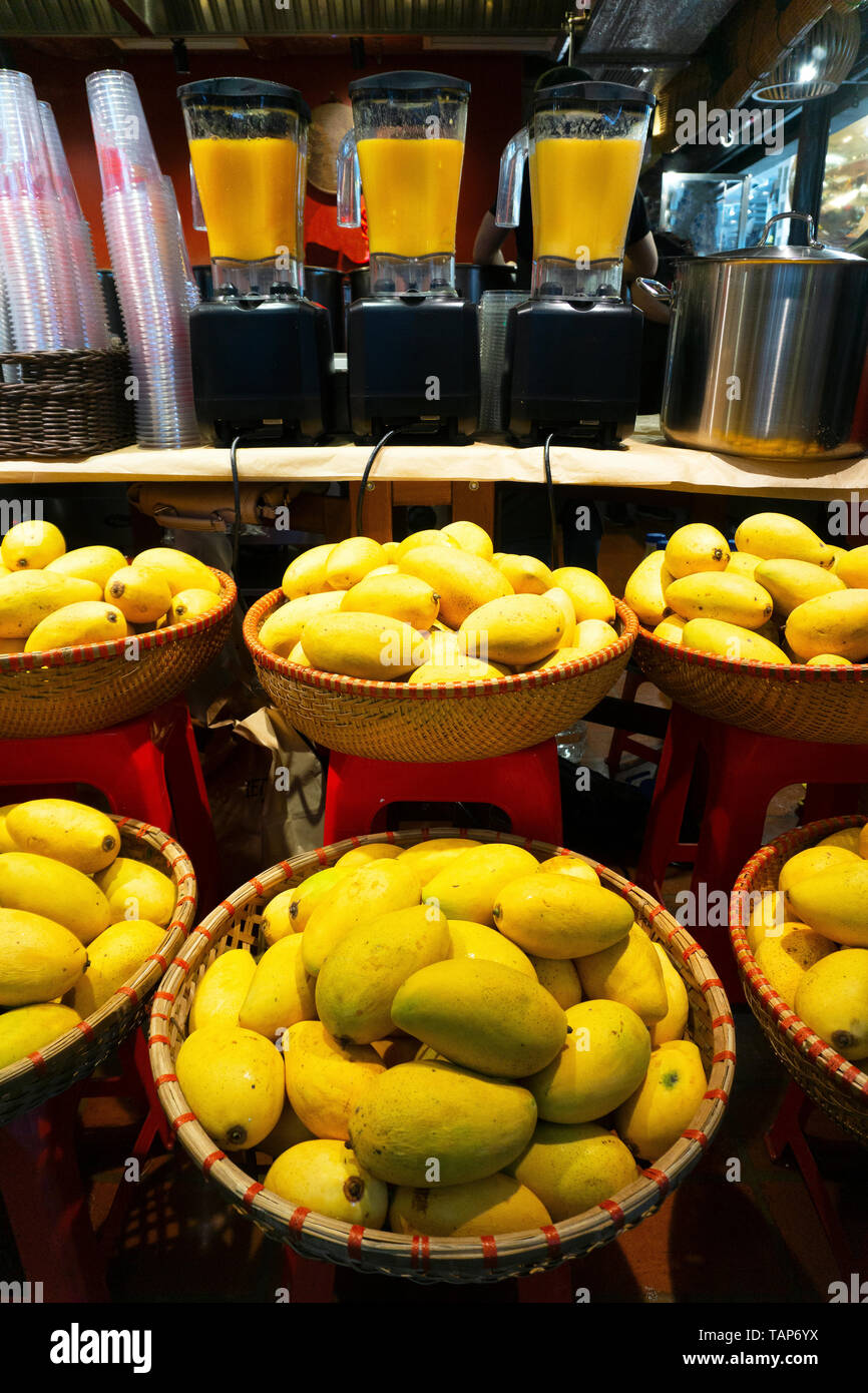 Mango shakes in the Vietnamese market. Fresh mango in basket at the market Stock Photo