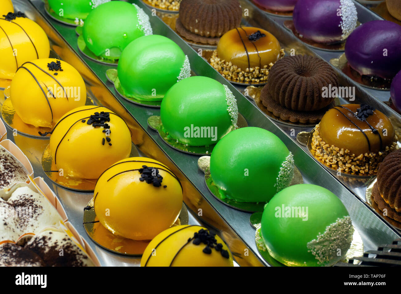 Cakes in a pastry shop. Showcase with cakes, pies, sweets. Trandy