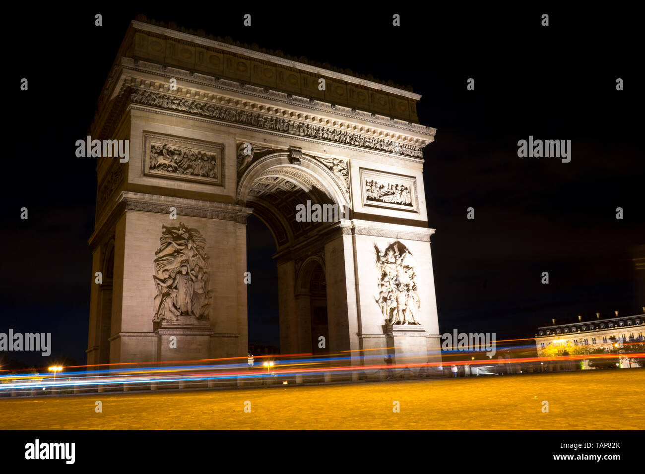 Arc De Triomphe with light trails, at night Stock Photo