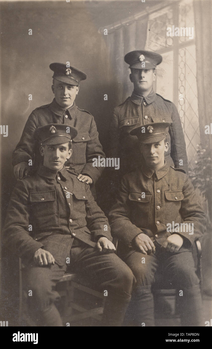 Vintage Photographic Postcard Showing Four British Soldiers. The Cap Badges  Appear To Indicate That They Served in The Royal Regiment of Fusiliers  Stock Photo - Alamy