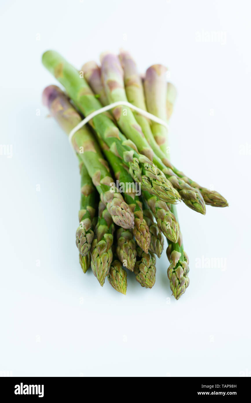 1 lb/0.5 kg of fresh organic asparagus on a white background. High resolution Stock Photo