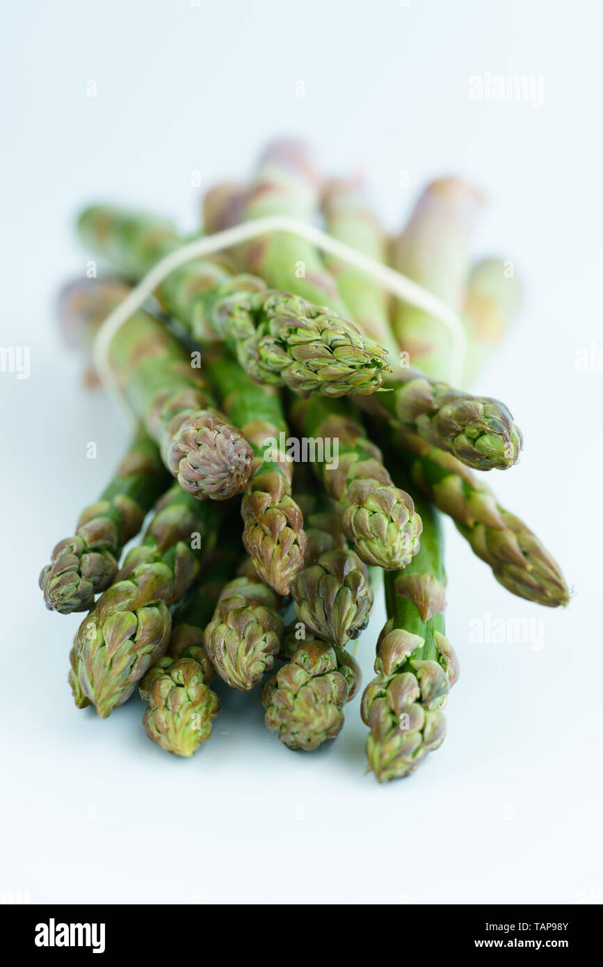 1 lb/0.5 kg of fresh organic asparagus on a white background. High resolution Stock Photo