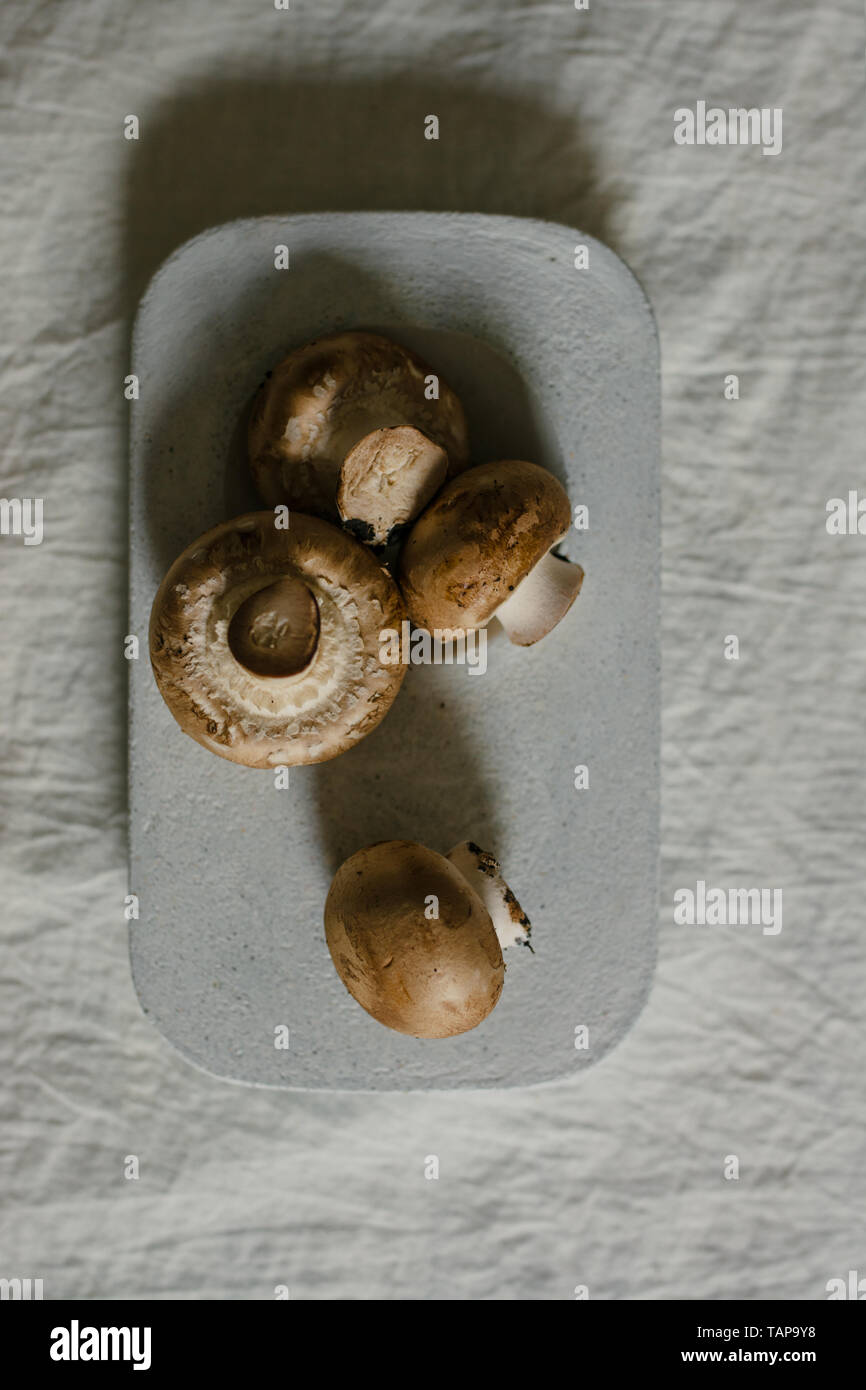 Fresh raw mushrooms, in blue Stone table , portobello variety Stock Photo