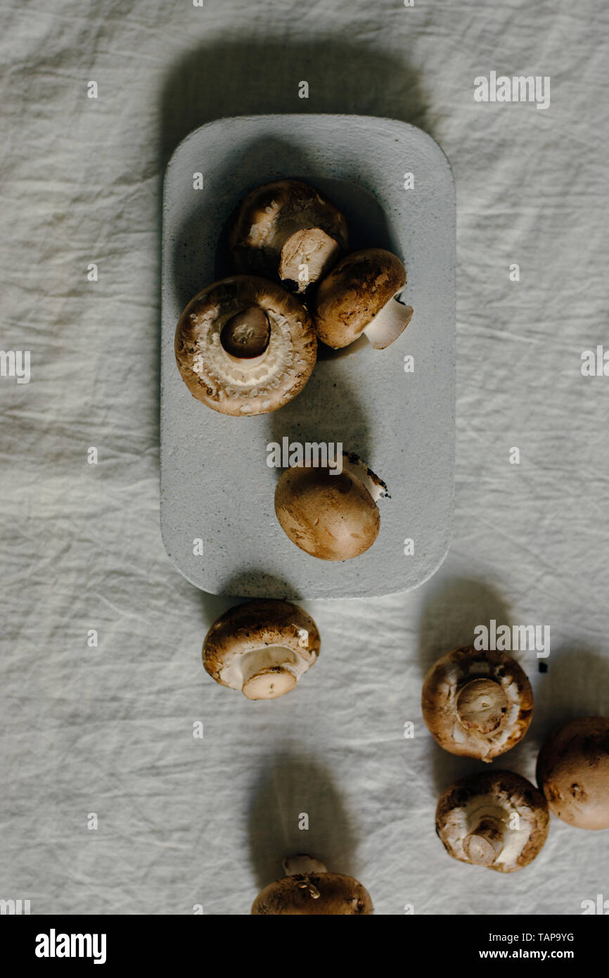Fresh raw mushrooms, in blue Stone table , portobello variety Stock Photo