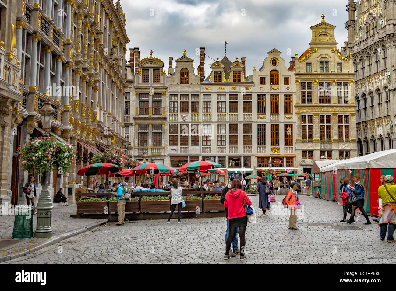 Visitors and tourists at The Grand Place in Brussels ,Belgium , a large square surrounded by ornately decorated buildings in the centre of Brussels Stock Photo