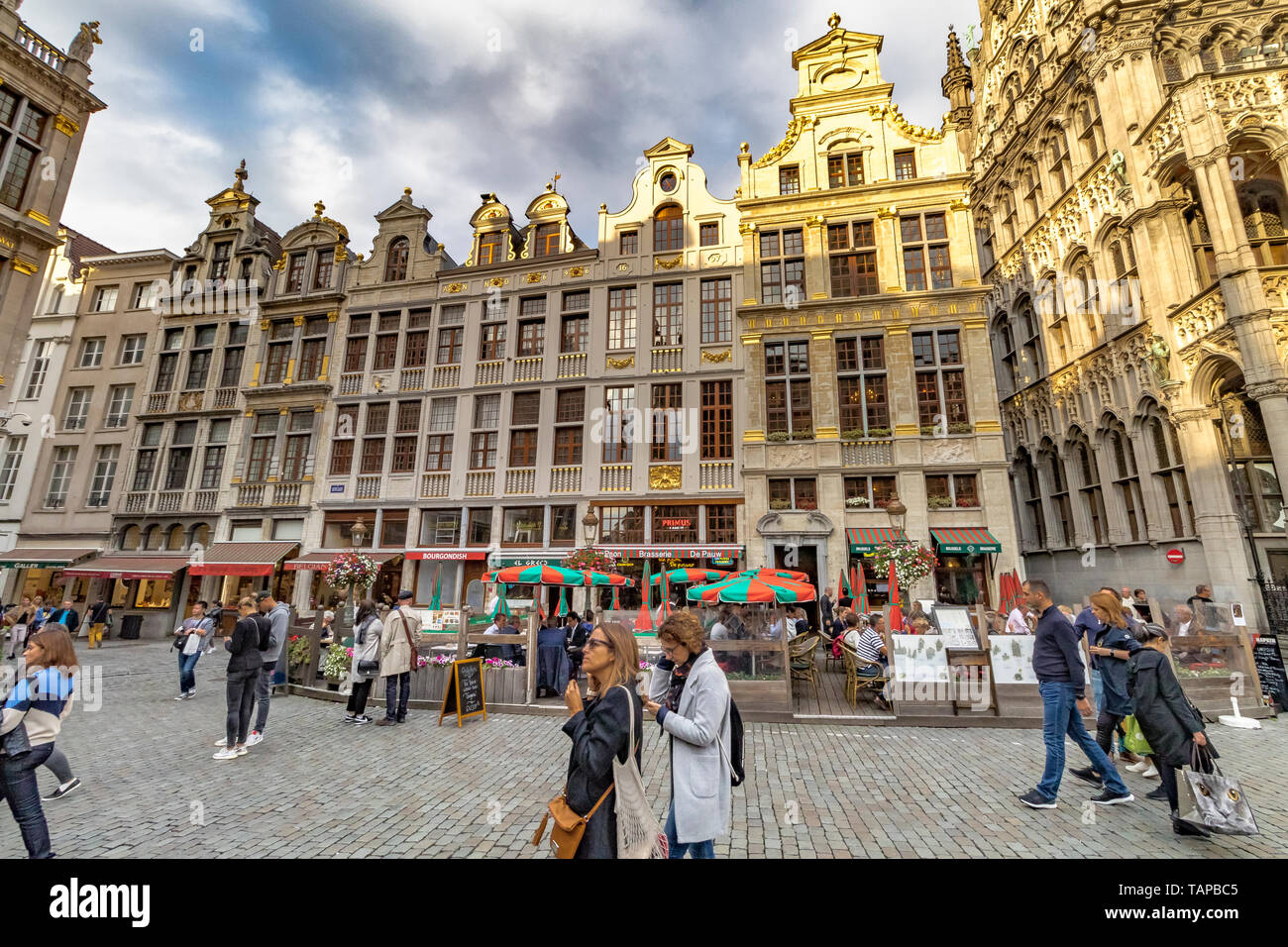 Visitors and tourists at The Grand Place in Brussels ,Belgium , a large square surrounded by ornately decorated buildings in the centre of Brussels Stock Photo