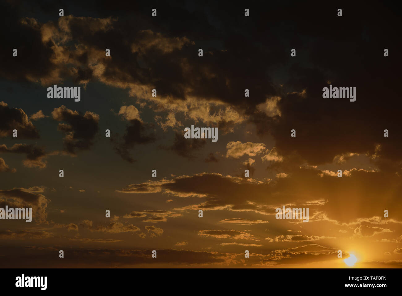 Dramatic sunset sky with orange colored clouds Stock Photo - Alamy