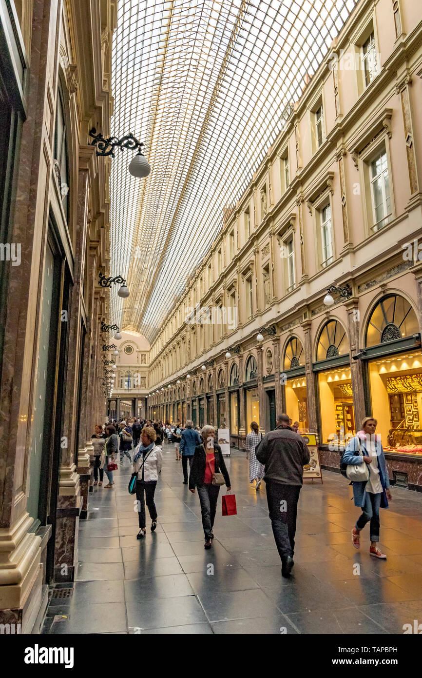 People walking through  Les Galeries Royales Saint-Hubert , an elegant glazed shopping arcade in Brussels ,Belgium Stock Photo